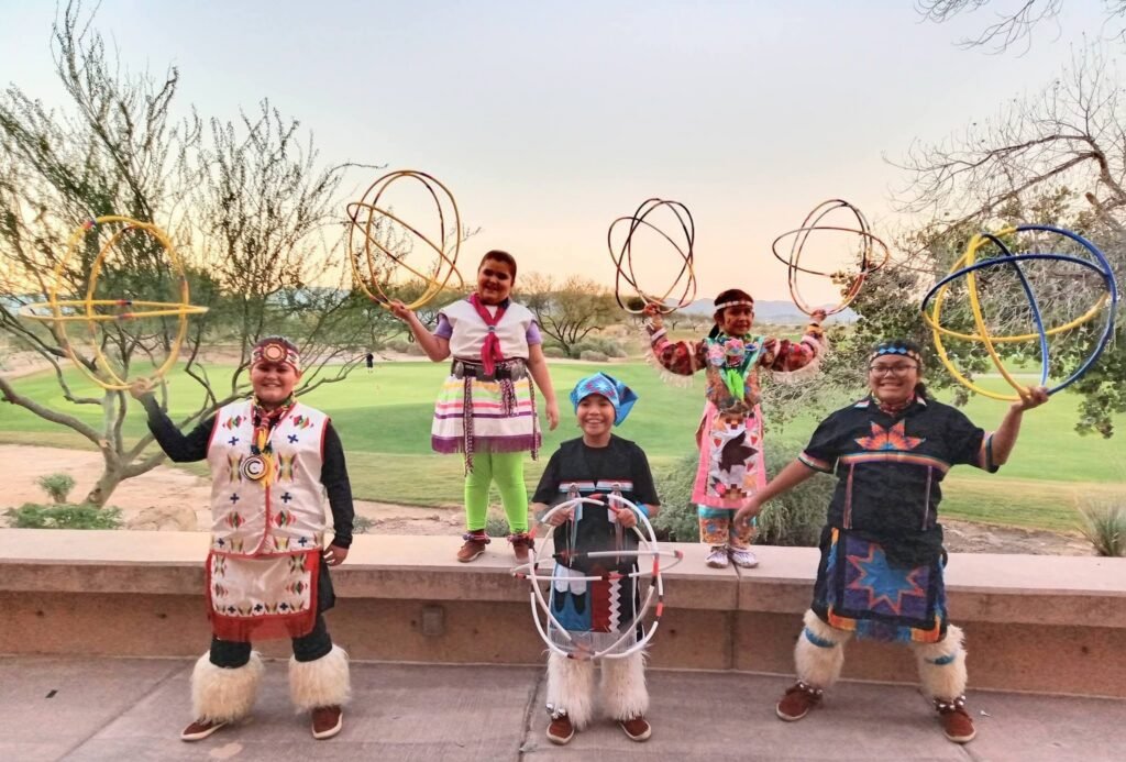 Phoenix Youth Hoop Dancers in regalia holding hoops
