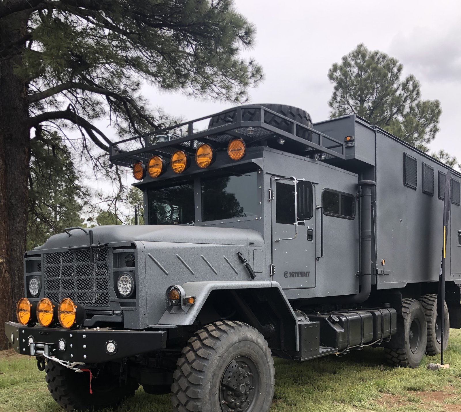 Custom military 6x6 overland build with rooftop tent at Overland Expo West