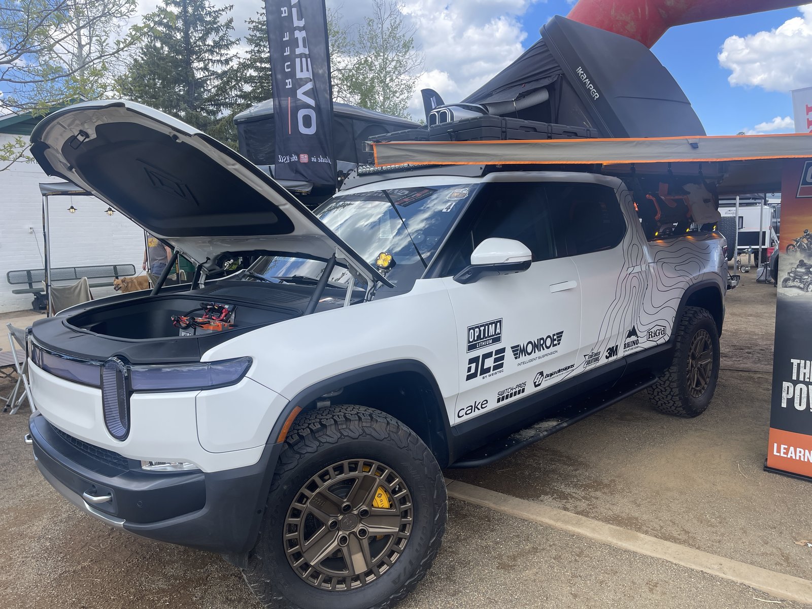 Rivian R1T with rooftop tent and topo wrap at Overland Expo West