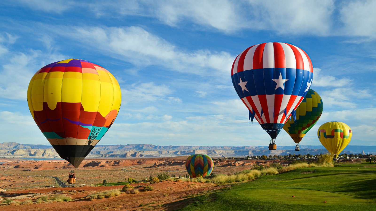 Hot air balloons rising over red rock near Lake Powell in Page, Arizona